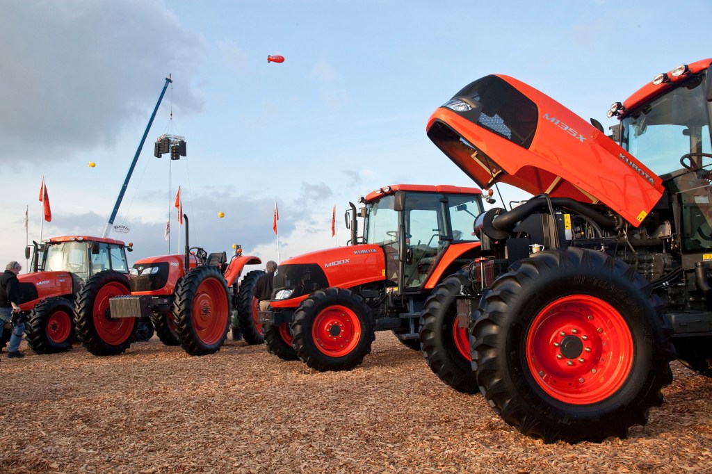 an array of Kubota tractor models are on display at an agriculture expo in California 