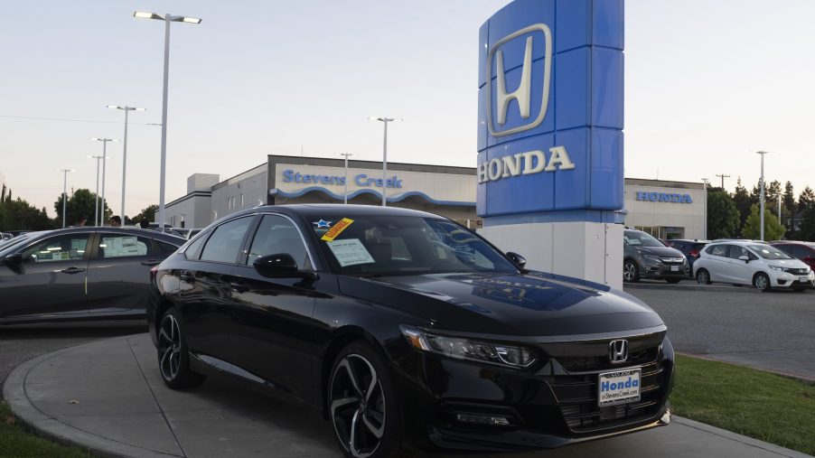 Honda logo and black Honda Accord vehicle are seen at a store in San Jose, California on August 27, 2019.