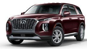 A maroon 2021 Hyundai Palisade against a white background.