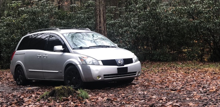 Nissan Quest stealth minivan camper van build in the forest 