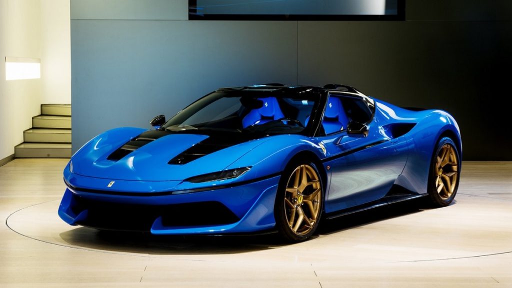 A blue, ultra rare Ferrari J50 on a showroom floor.