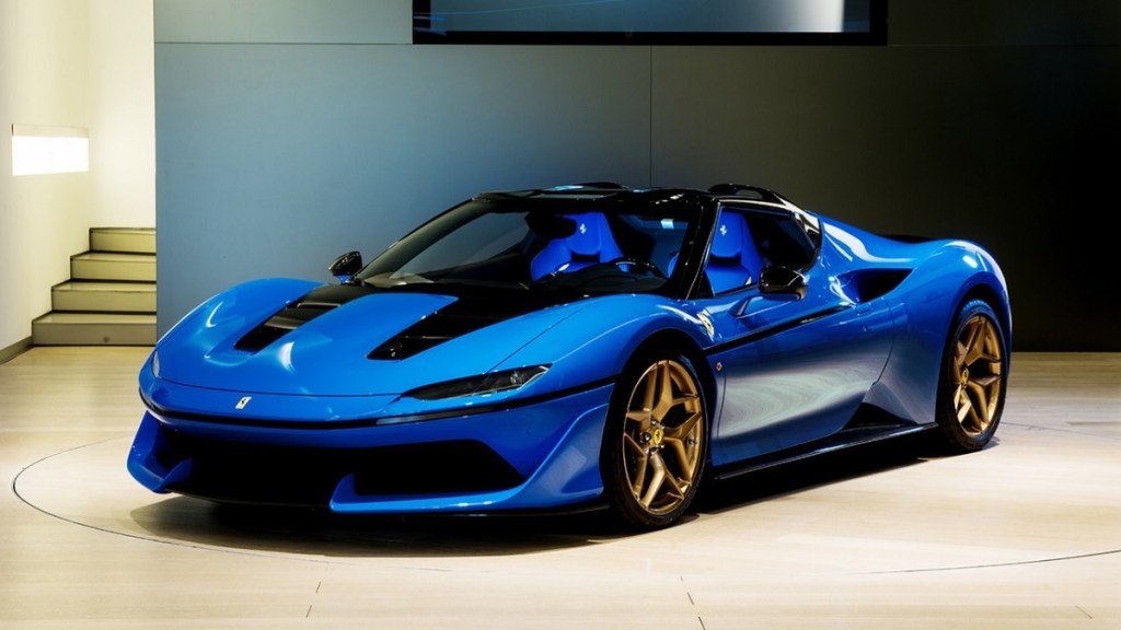 A blue, ultra rare Ferrari J50 on a showroom floor.