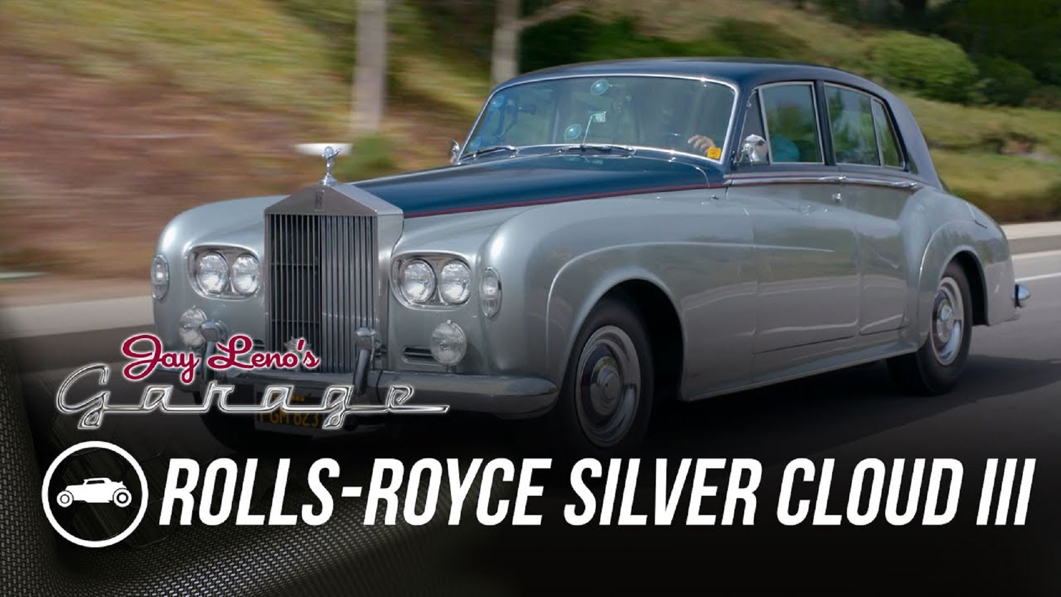 Jay Leno driving John Frankenheimer's silver-and-blue 1965 Rolls-Royce Silver Cloud III down the road
