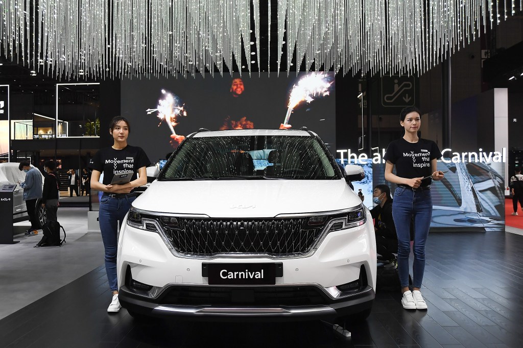 A white Kia Motor Carnival car is on displayed during the 19th Shanghai International Automobile Industry Exhibition