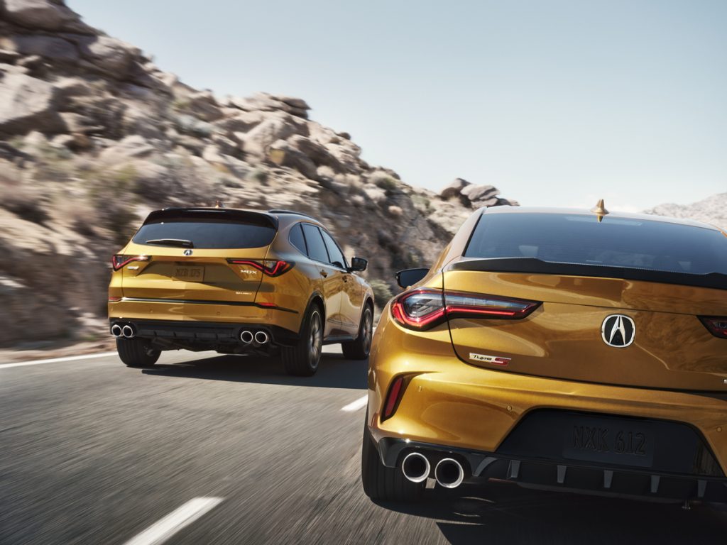 An image of two Acuras out on the road.