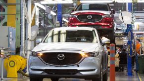 A worker drives a Mazda Motor Corp. CX-5 sports utility vehicle (SUV) on the assembly line at the Mazda Sollers Manufacturing Rus LLC plant