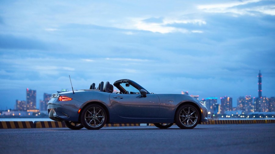 A 2021 Mazda MX-5 Miata parked at dusk, the Miata is the best new convertible according to Edmunds