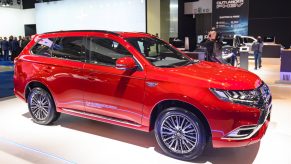 Red Mitsubishi Outlander PHEV crossover plug-in hybrid SUV on display at Brussels Expo