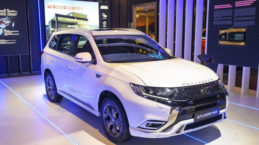 White Mitsubishi Outlander PHEV crossover plug-in hybrid SUV on display at Brussels Expo