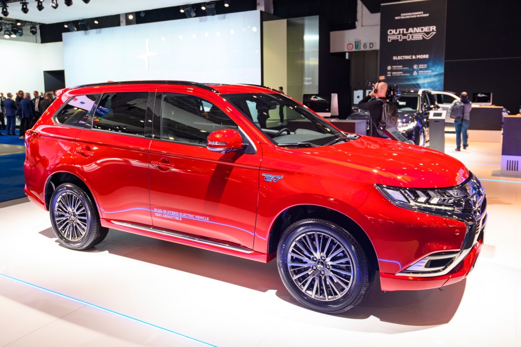 Red Mitsubishi Outlander PHEV crossover plug-in hybrid SUV on display at Brussels Expo