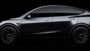 A black Tesla Model Y against a dark background.