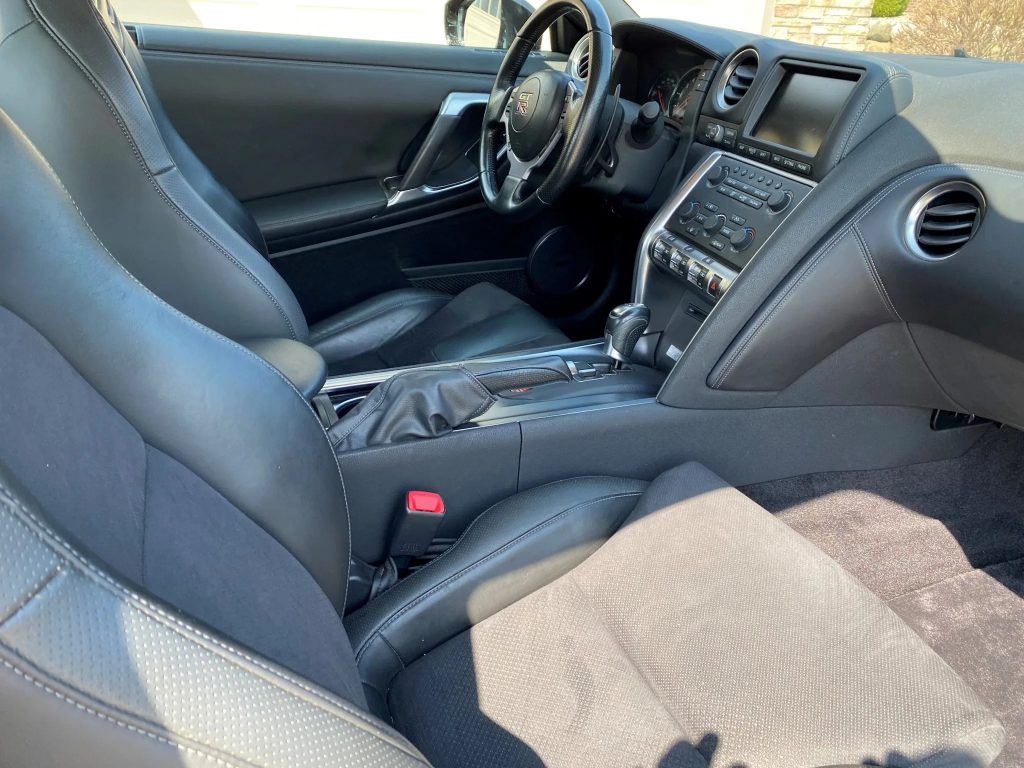 The leather-upholstered front seats and dashboard of a modified 2010 Nissan GT-R Premium