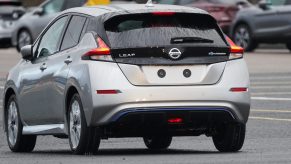 A newly manufactured gray Nissan Leaf electric vehicle is driven from the production line to be parked at the Nissan Motor Co. plant