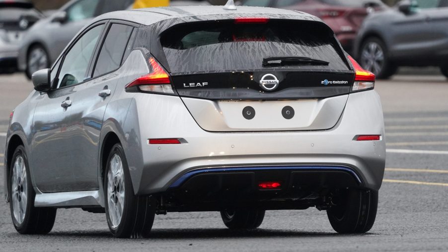 A newly manufactured gray Nissan Leaf electric vehicle is driven from the production line to be parked at the Nissan Motor Co. plant