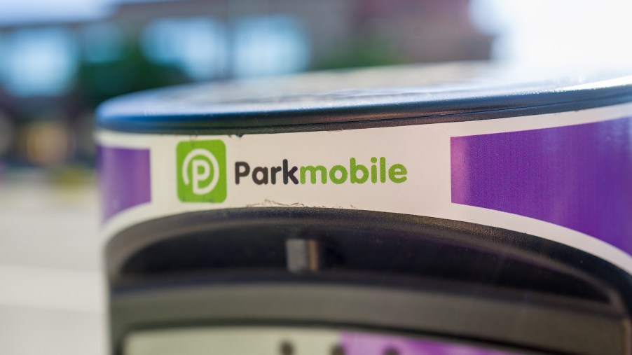 A white and purple parking meter with a black and green ParkMobile logo in downtown Walnut Creek, California, in April 2019