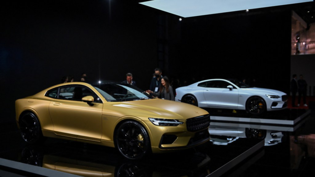 A gold Polestar 1 next to a White Polestar 1 at the 19th Shanghai International Automobile Industry Exhibition in Shanghai.