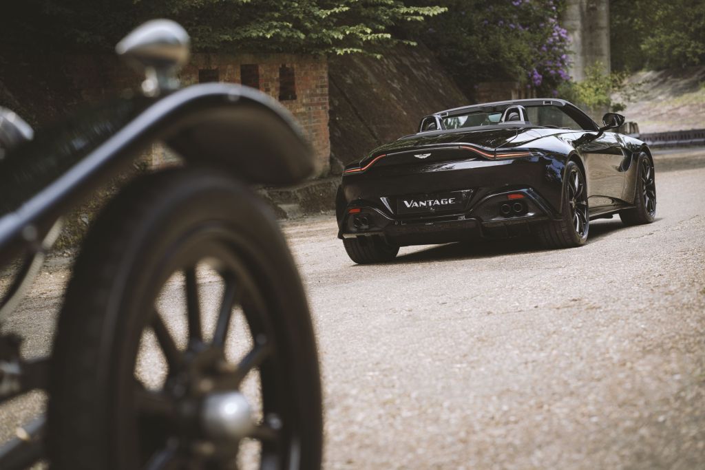 The rear 3/4 view of the black A3-inspired Q by Aston Martin Vantage Roadster rear 3/4 with the 1921 Aston Martin A3 in the foreground