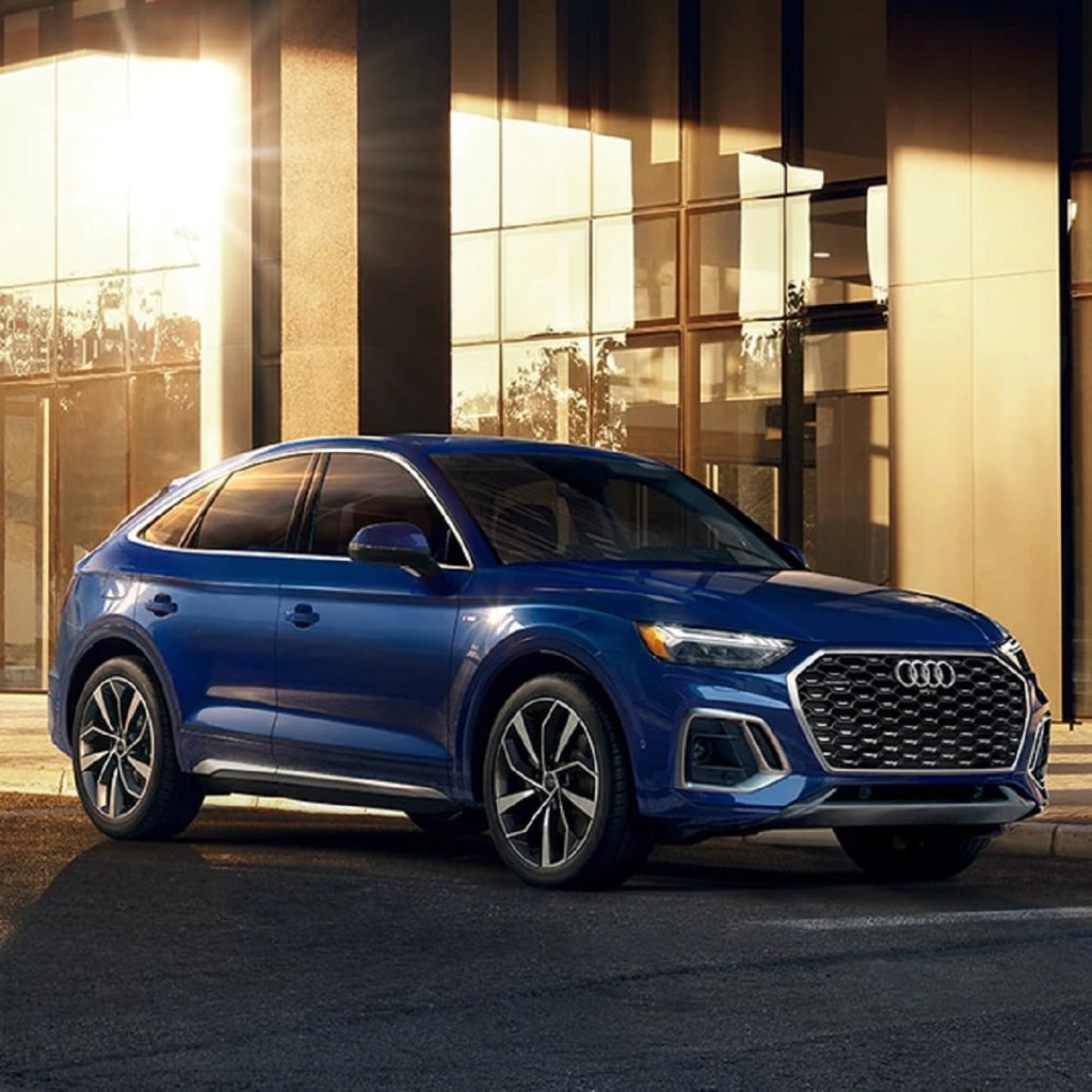 A blue 2021 Audi Q5 parked outside of a building.