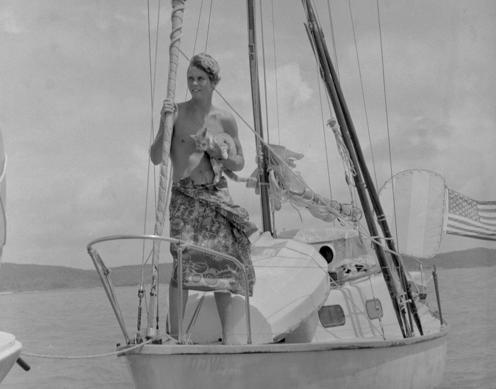 Robin Lee Graham, 18, holds his ginger tabby cat, Avanga, aboard his 24-foot sloop in 1967
