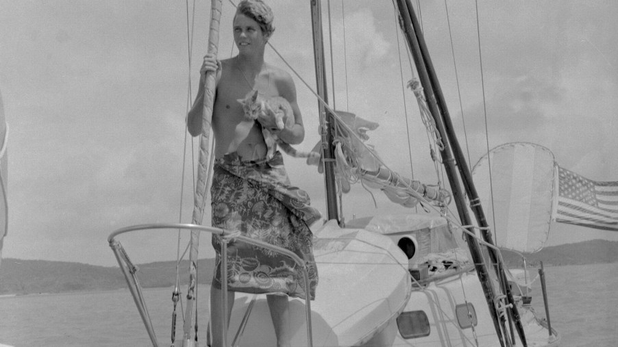 Boating alone, Robin Lee Graham, 18, holds his ginger tabby cat, Avanga, aboard his 24-foot sloop in 1967