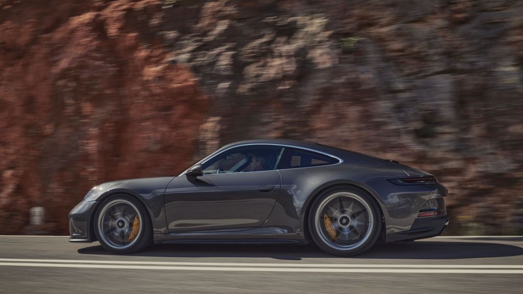 A grey Porsche 911 GT3 hightails it down a canyon road