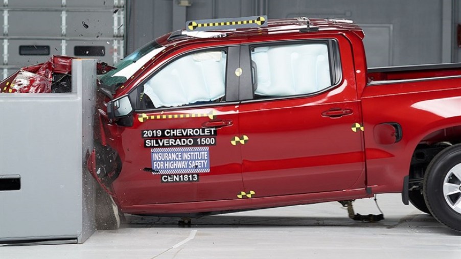 A red Chevy Silverado 1500 is smashed into a wall.