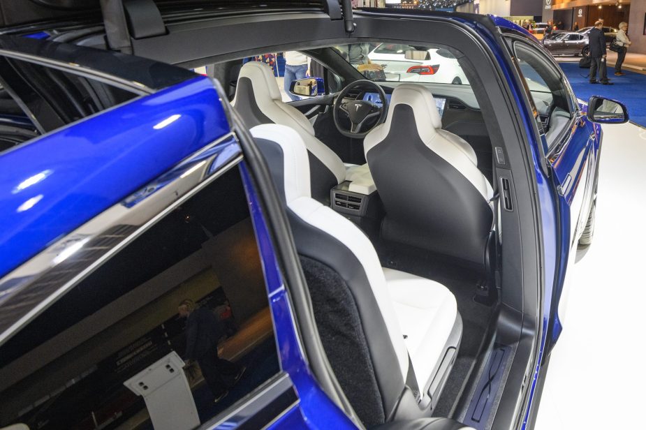 Open Falcon wing doors on a Tesla Model X 90D full electric luxury crossover SUV car on display at Brussels Expo