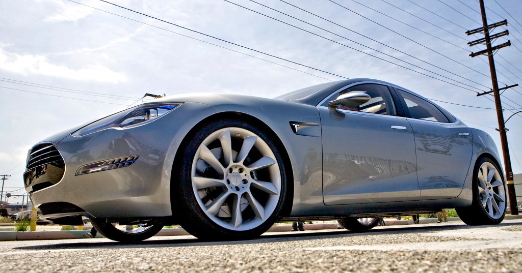 The Tesla Motors Inc. Model S electric car sits under power lines after being unveiled at the Space Exploration Technologies (SpaceX) factory.