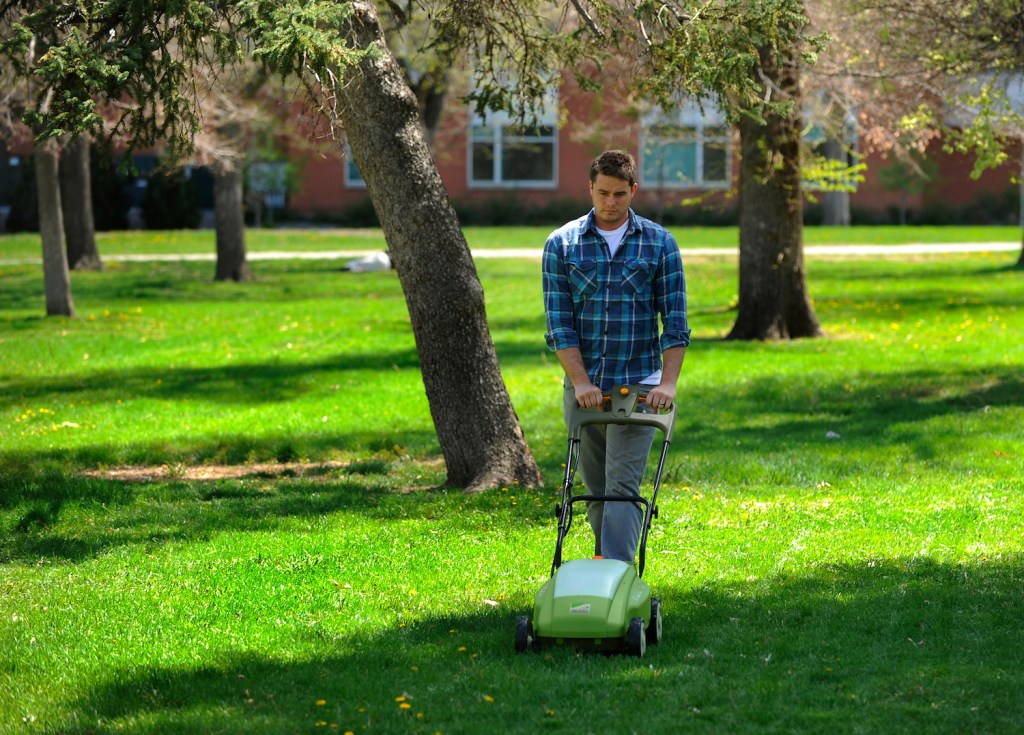 A man testing an electric lawn mower to find the best electric lawn mower