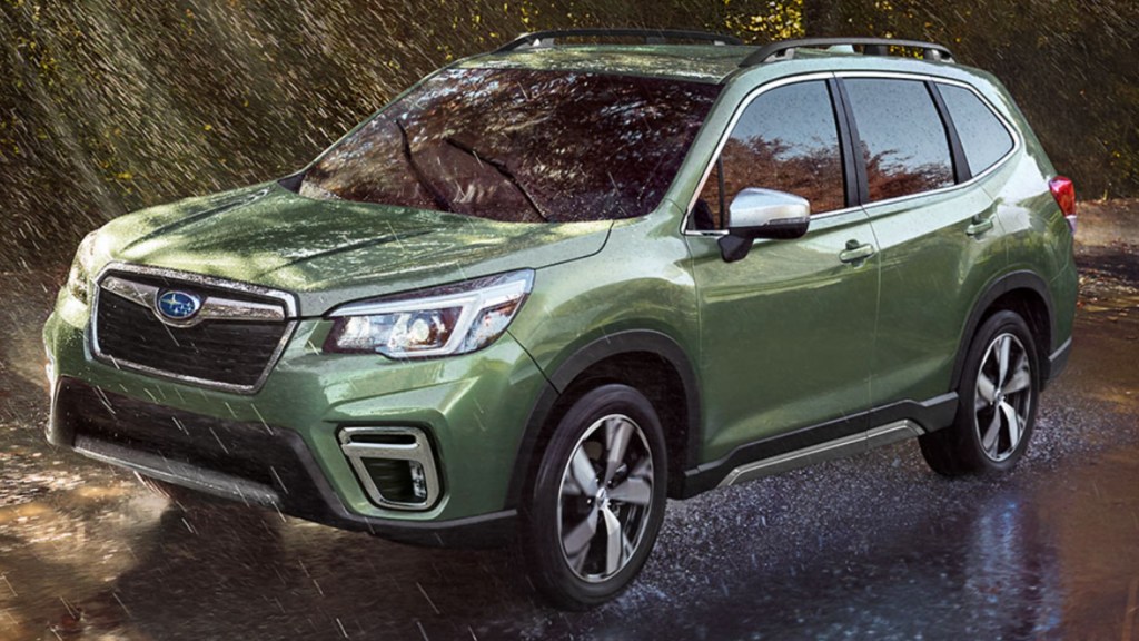 A Green 2021 Subaru Forester driving in the rain.