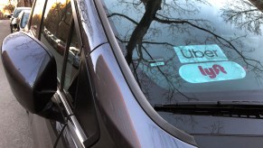 Uber and Lyft signs on a car windshield in Queens, New York