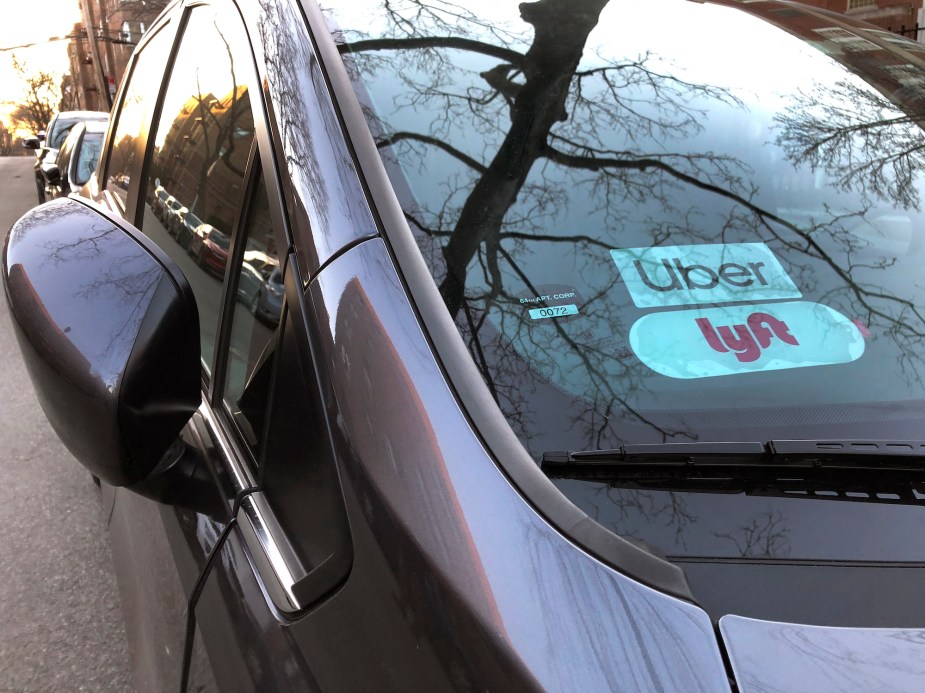 Uber and Lyft signs on a car windshield in Queens, New York