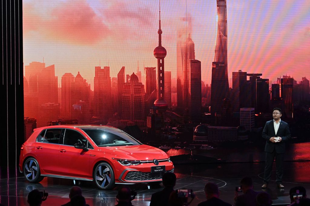 Guo Yongfeng, President of Faw-Volkswagen Sales, presents the new red Volkswagen Golf GTI car during the 19th Shanghai International Automobile Industry Exhibition