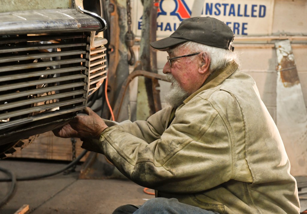 A mechanic working on a classic car. If you're selling a classic car, you'll need records from your mechanic.