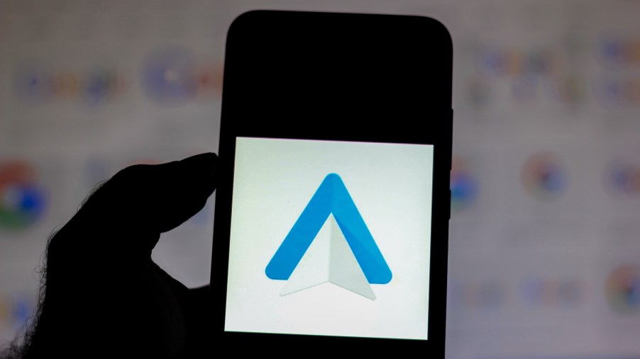 In this photo illustration the Android Auto logo is seen displayed on a smartphone.