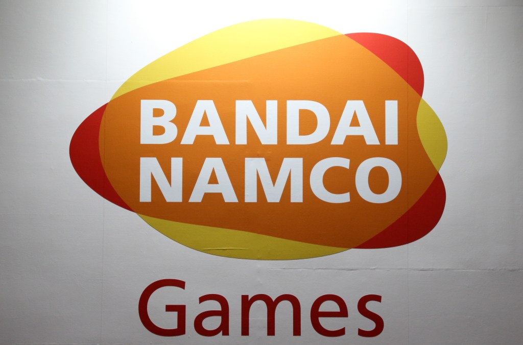 the Bandai Namco logo on a background of red, yellow, and orange