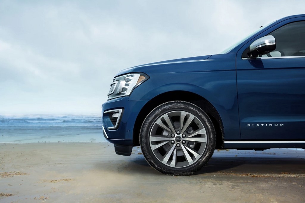 A blue Ford Expedition on a beach. Consumer Reports recommends buying a vehicle with pedestrian detection technology. 