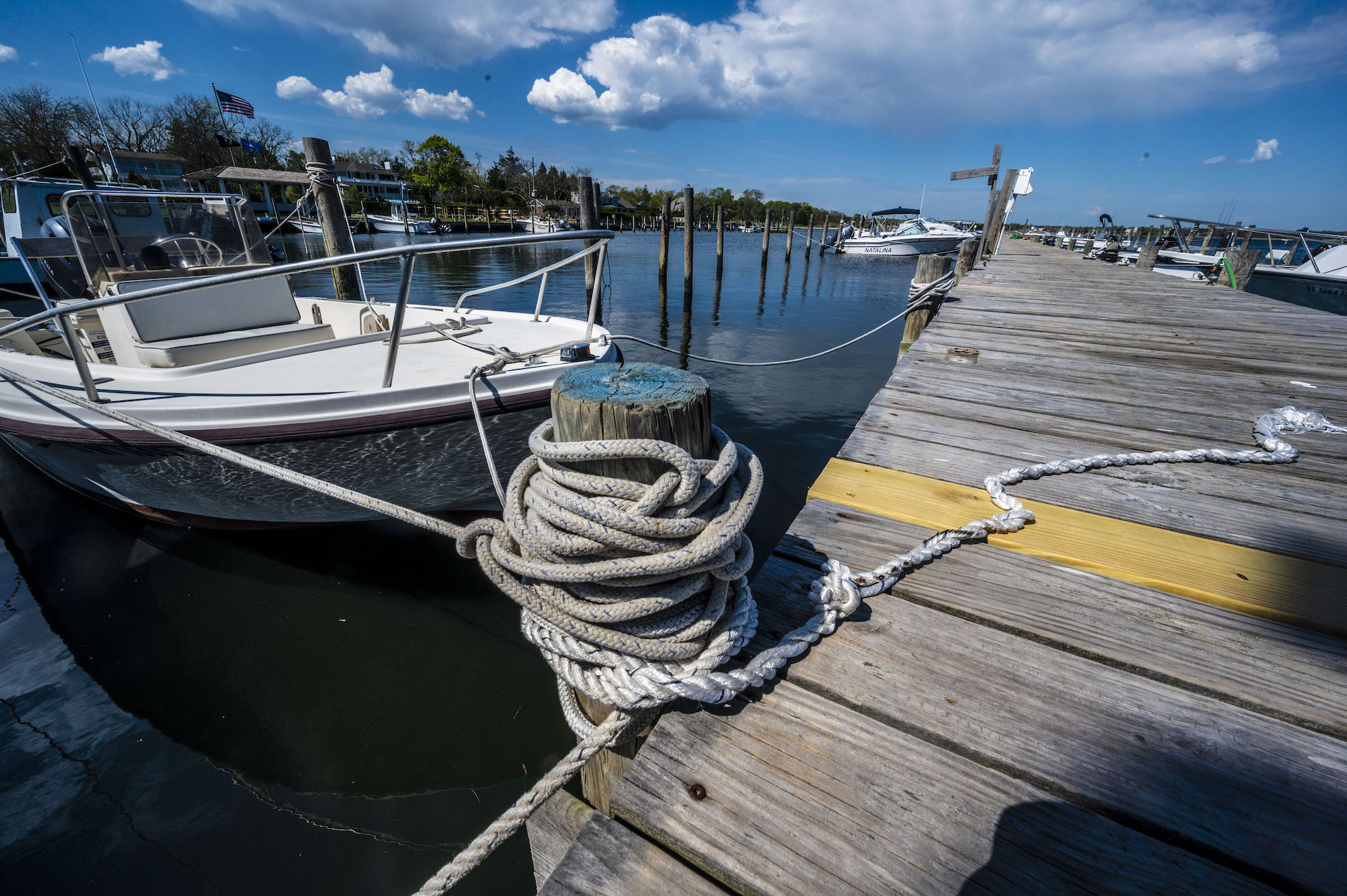 A white center-console boat is docked at Bellport Marina in Bellport Village, New York, on May 15, 2021