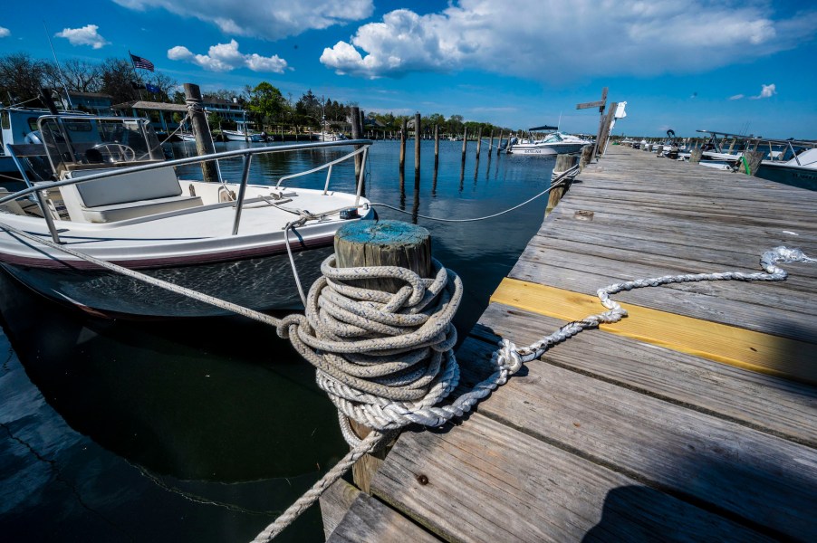 A white center-console boat is docked at Bellport Marina in Bellport Village, New York, on May 15, 2021