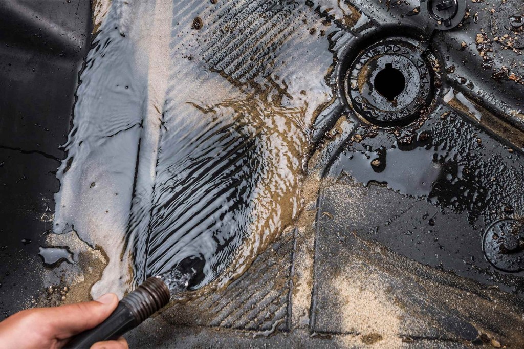 A man washes out the foot-wells of the new Ford Bronco