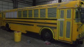 A yellow bus prepared for painting