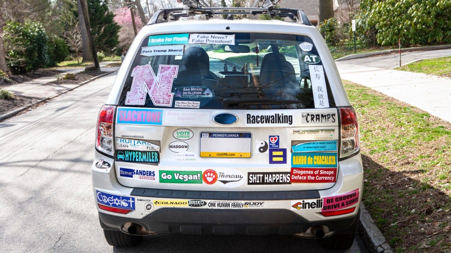 Rear view of a white car with many bumper stickers in Swarthmore, Pennsylvania