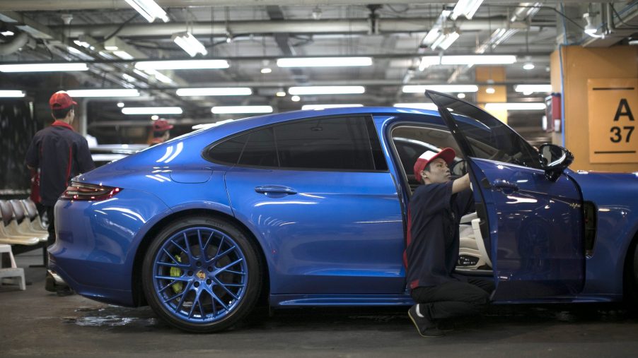 A worker polishes a Porsche AG Panamera