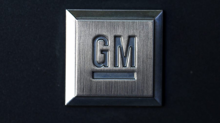 A General Motors logo stamped into a square metal plate