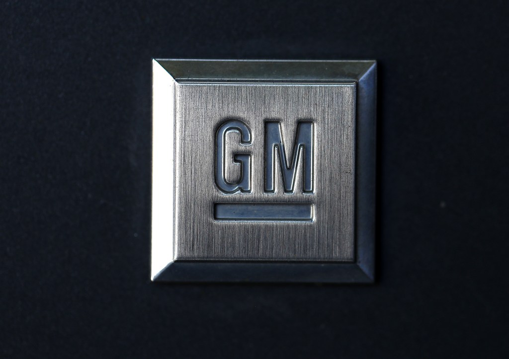 A General Motors logo stamped into a square metal plate