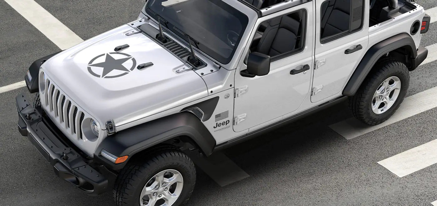 A white Jeep Wrangler with a black star on the hood