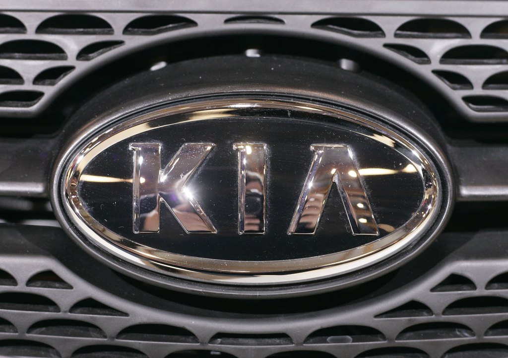A chrome Kia emblem on a front grille
