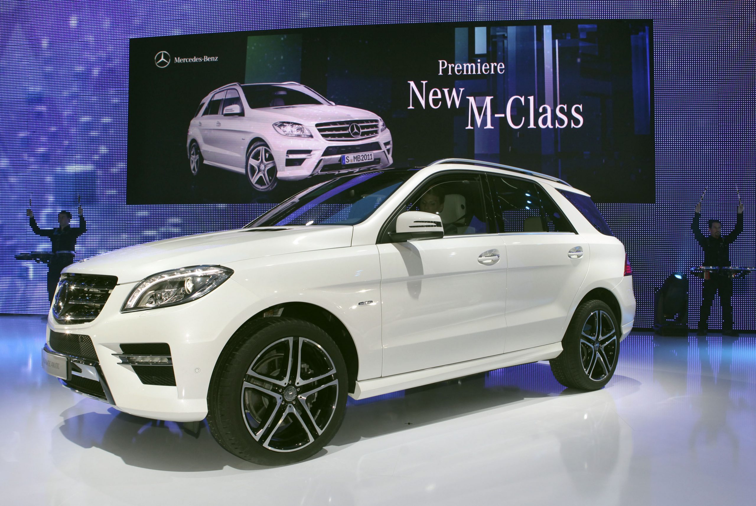A white Mercedes M-Class SUV on display