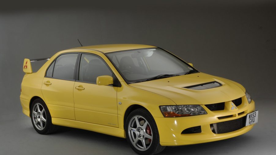 A yellow Mitsubishi Evolution sport sedan
