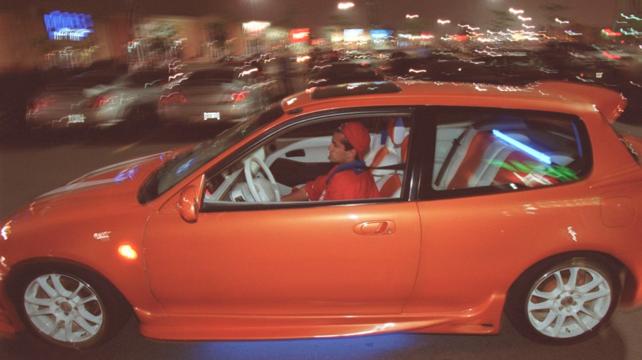 18-year-old Faraz Matin drives his modified 1993 Honda Civic through a parking lot near Collossus an